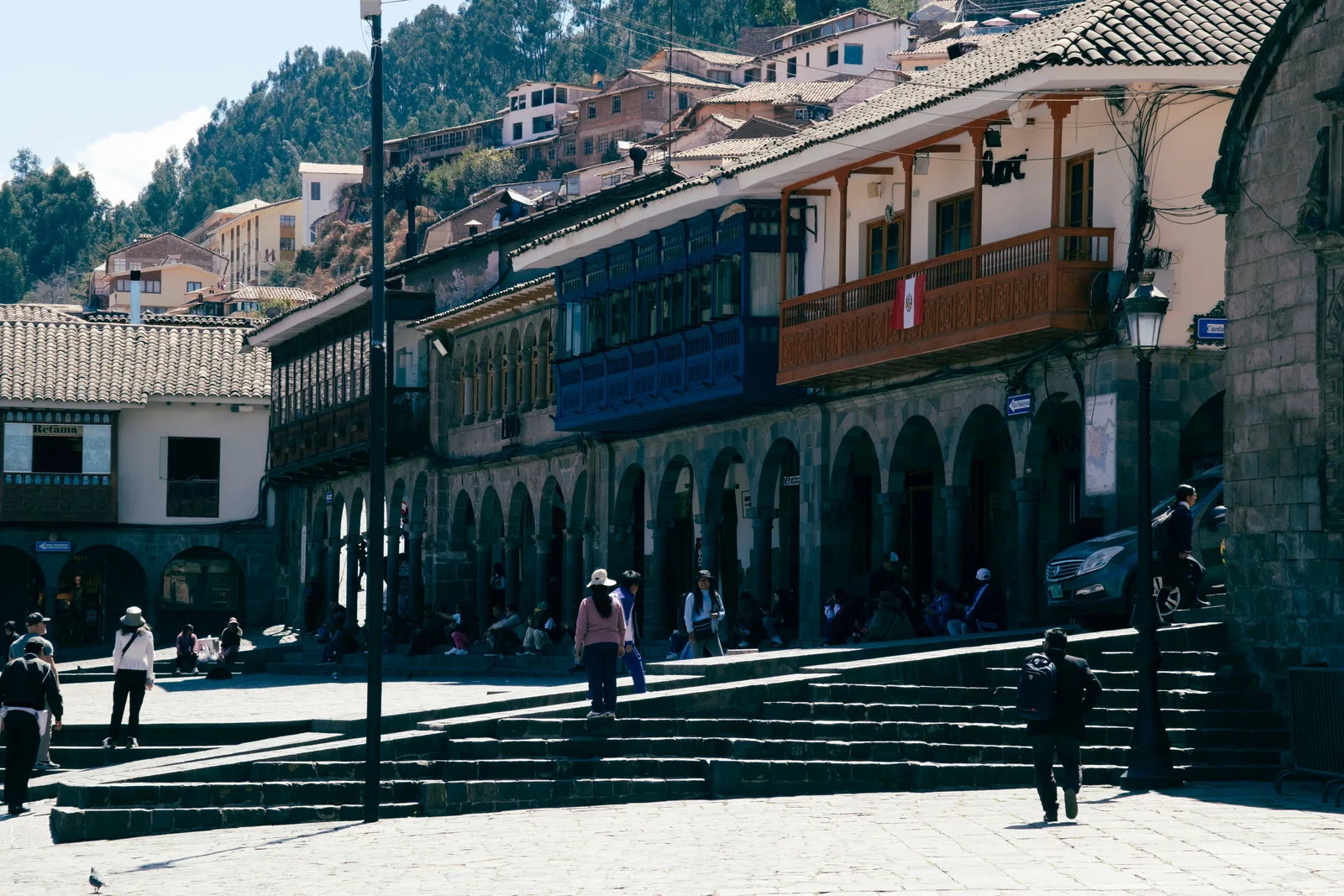 Travellers walking a high-altitude town street — ordinary tourism, at an elevation where altitude illness affects a large share of arrivals