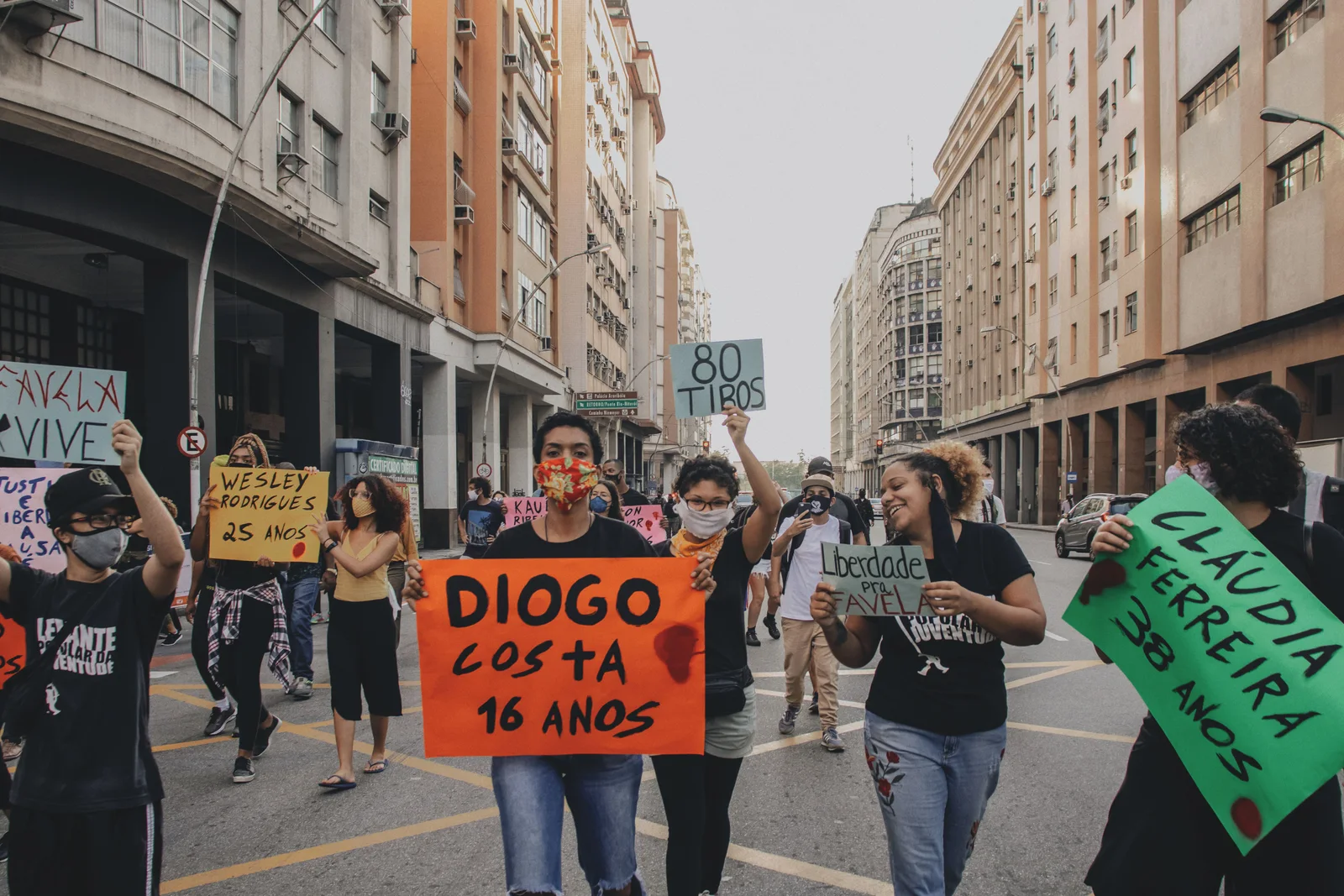 A group protest on Rio streets advocating for justice and equality.