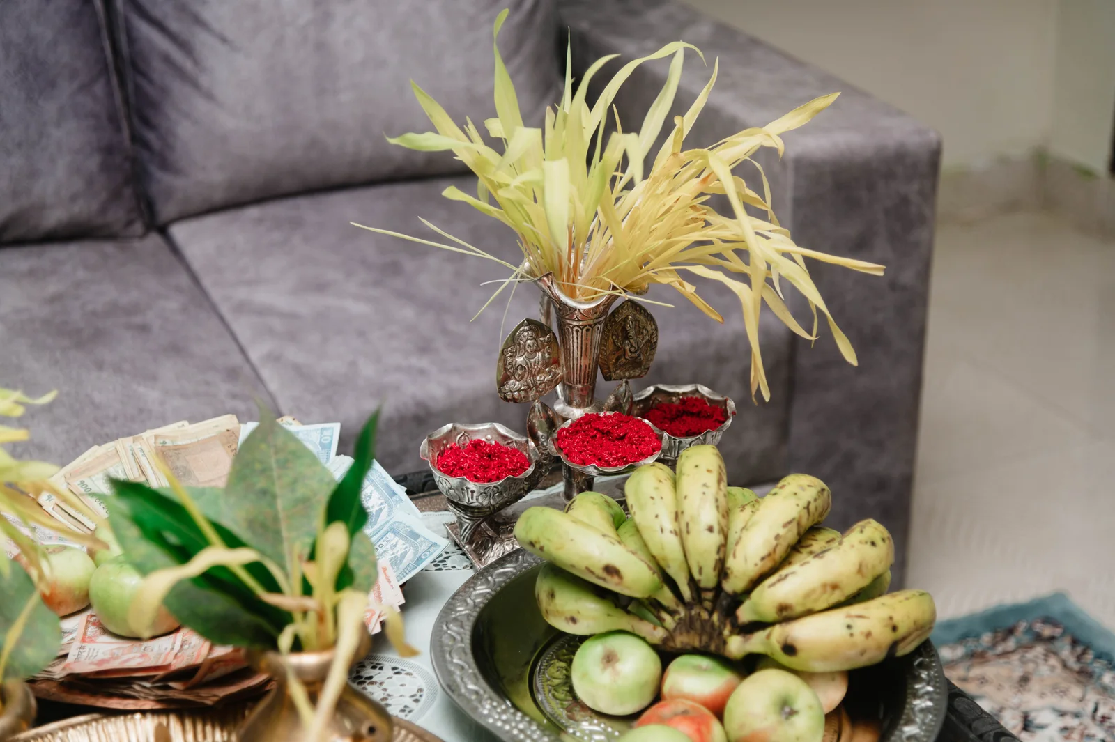 A close-up of fruits and tikka in a traditional Dashain festival setup indoors in Nepal.