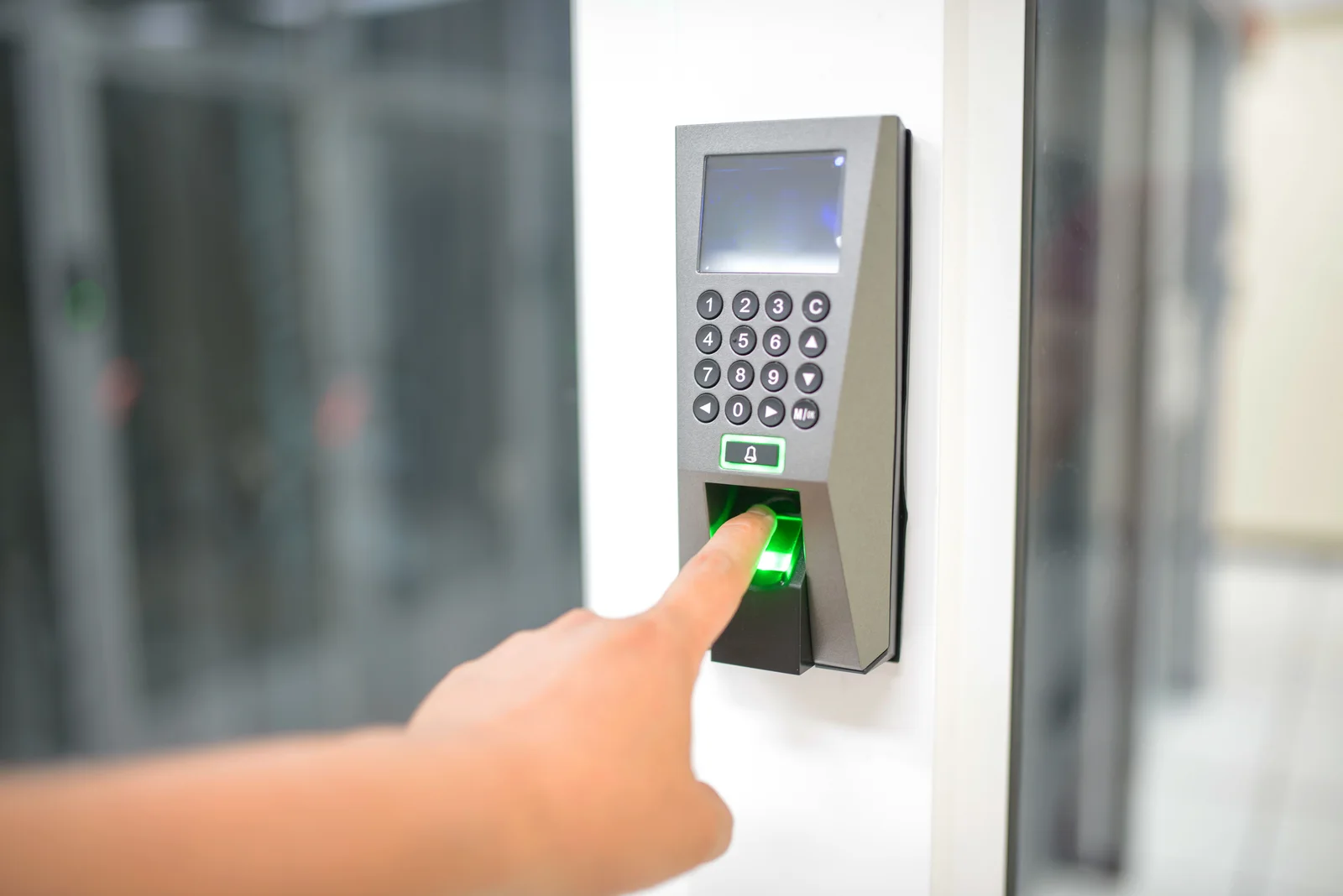 A finger being placed on a fingerprint scanner