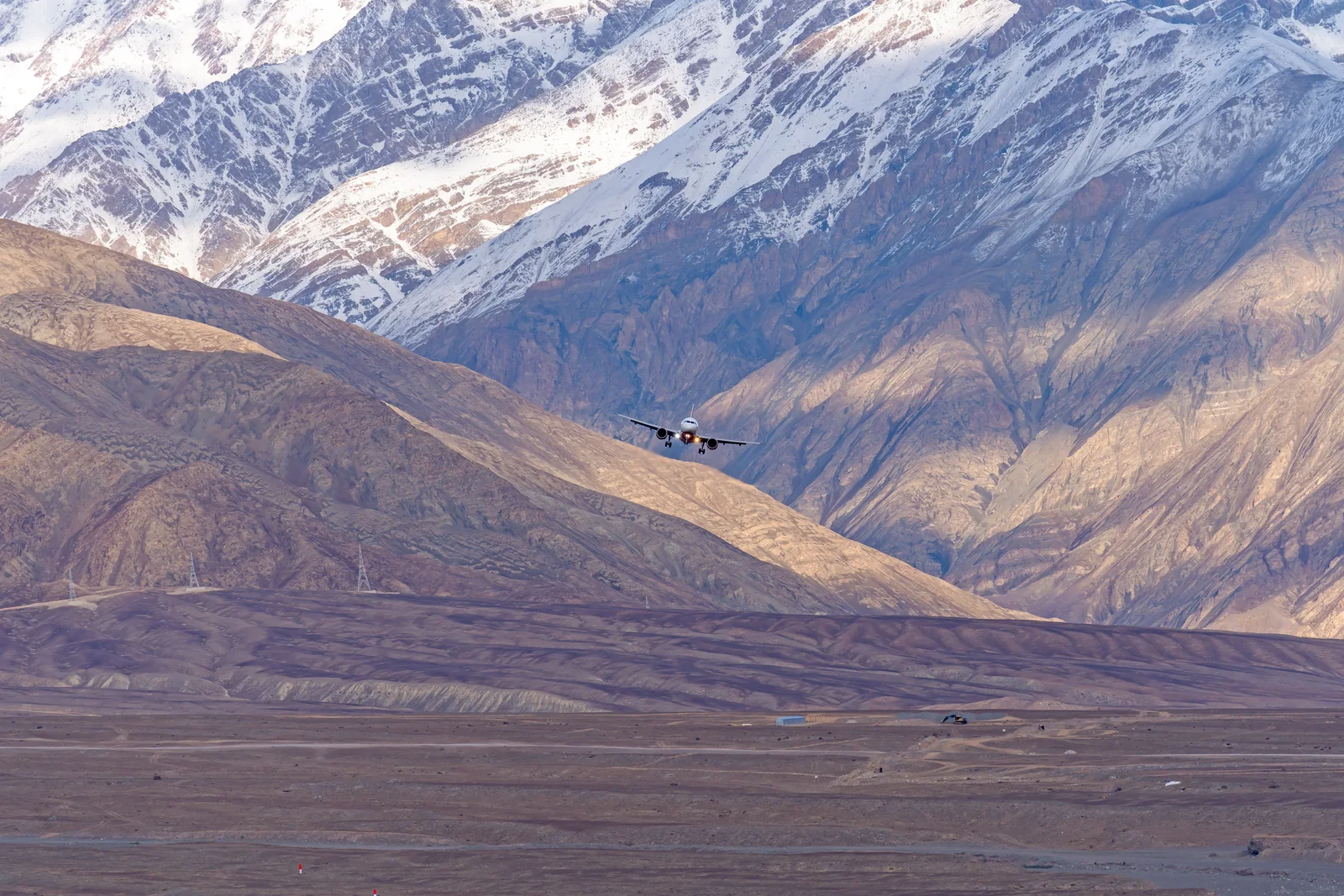 An aircraft descending into a high mountain valley