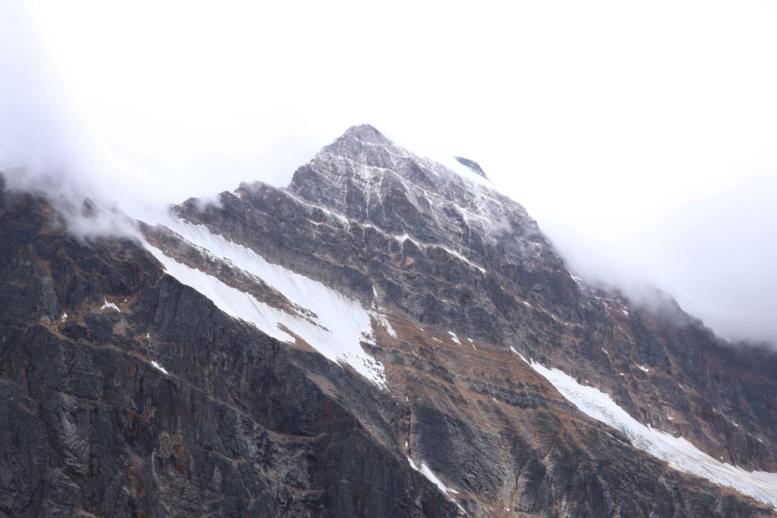 Breathtaking view of Mount Edith Cavell in Jasper National Park enveloped in fog.