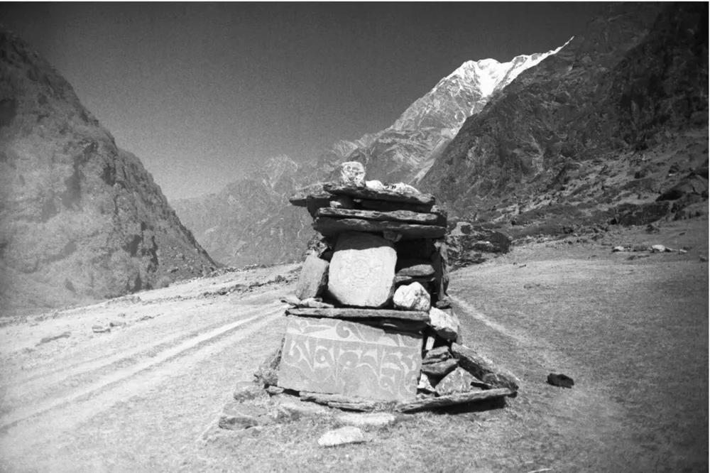 A mani stone chorten beside the Langtang trail with a snow peak behind, 1999