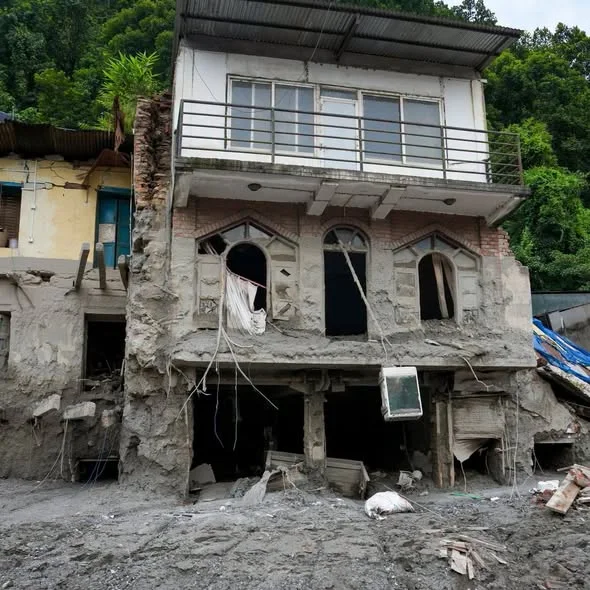A three-storey house with its lower floors gutted and coated in dried mud