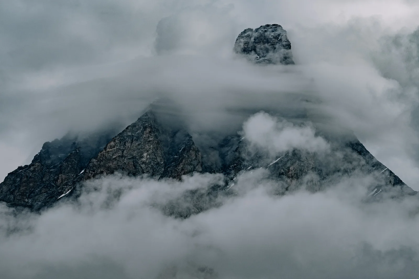 A rocky mountain summit wrapped in cloud