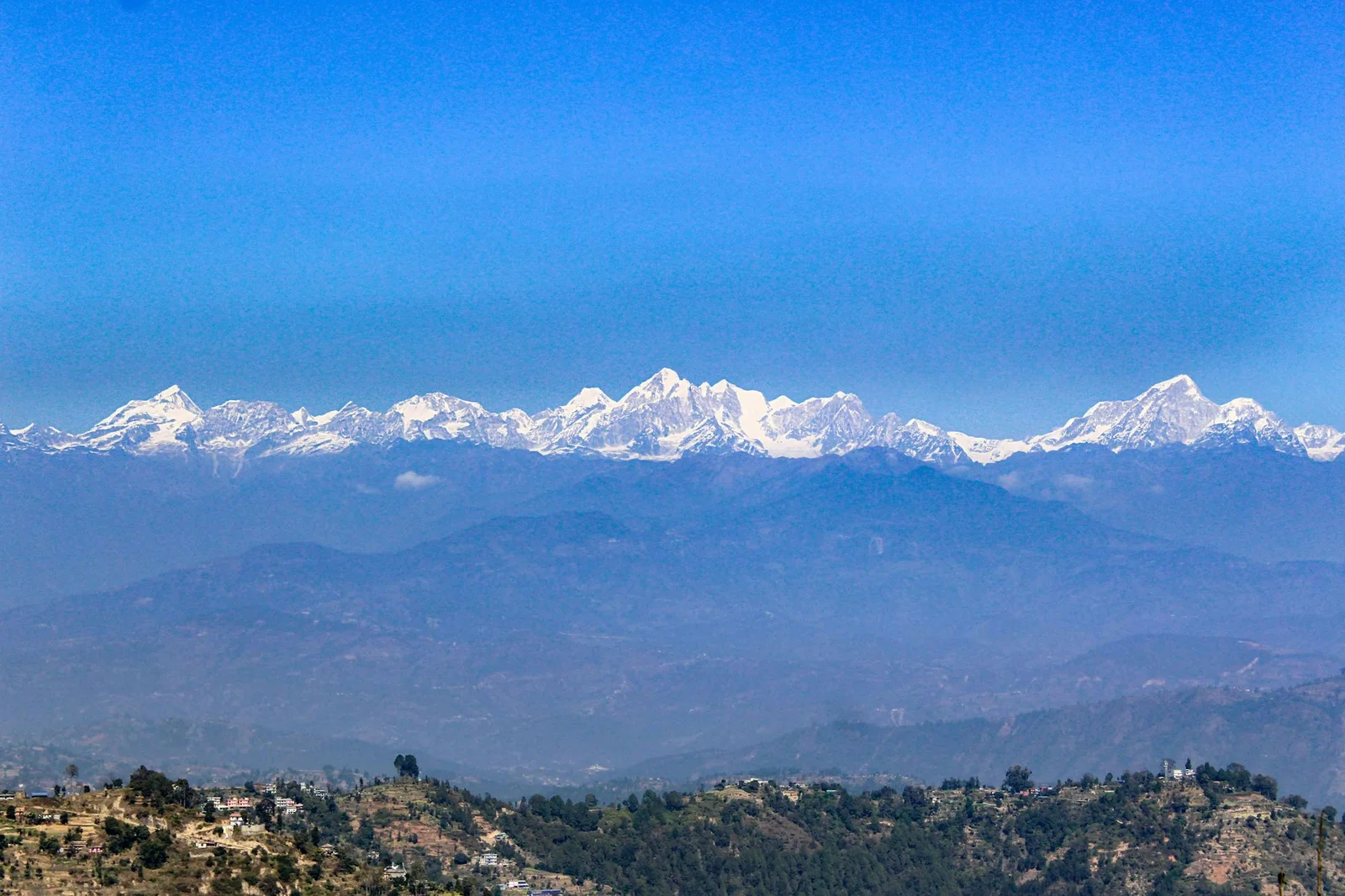 Snow-capped mountains under a clear blue sky