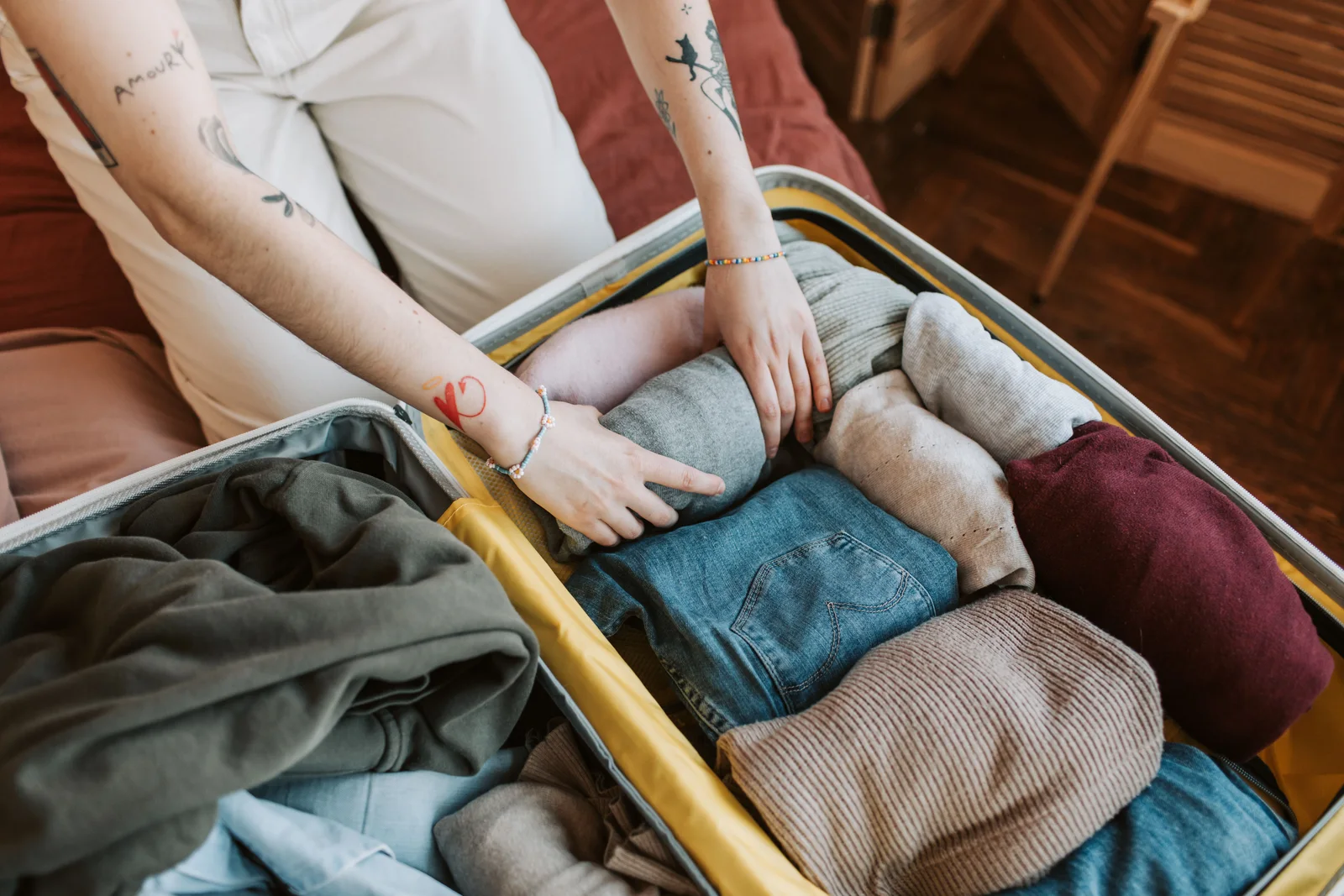 Clothing being folded and packed — the decision that matters is how few shirts go in, not which brand