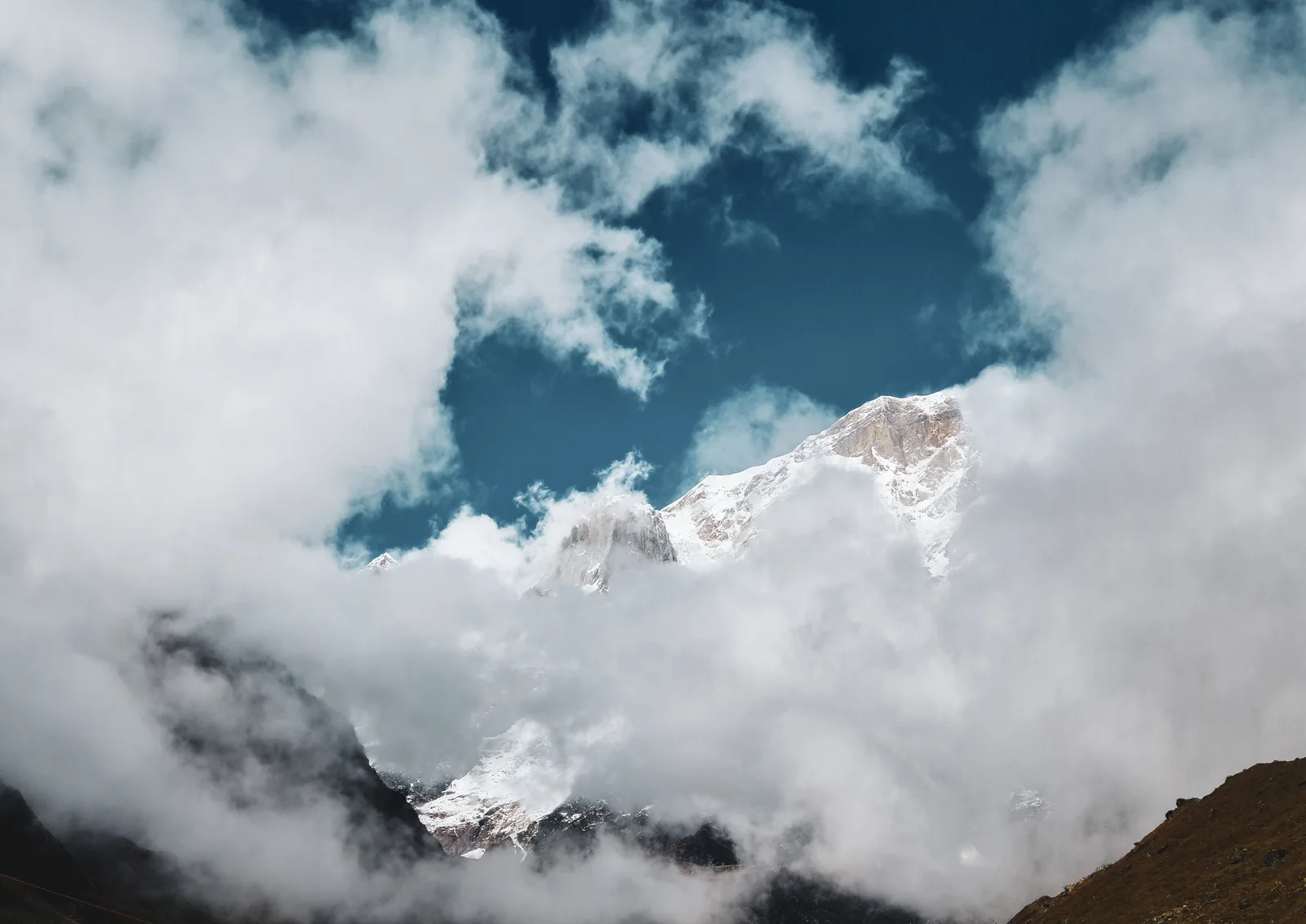 A snow peak appearing through cloud