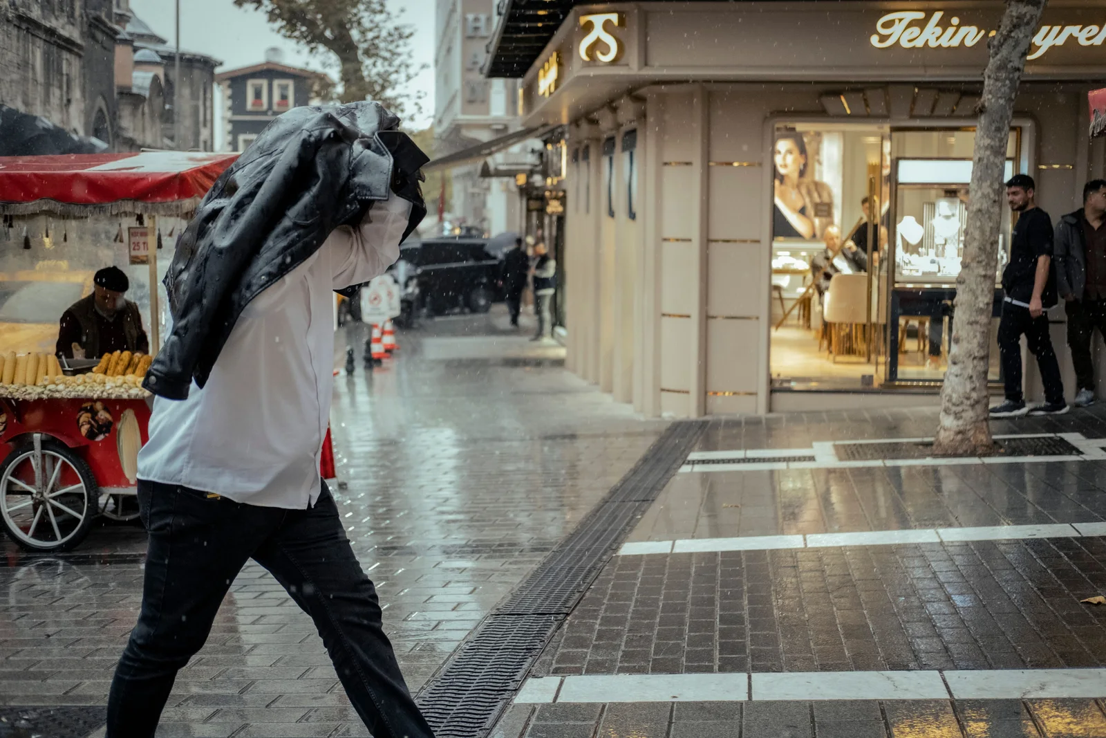 A rain jacket soaked through on the outer face — when the outer wets out, sweat can no longer escape and the inside feels damp